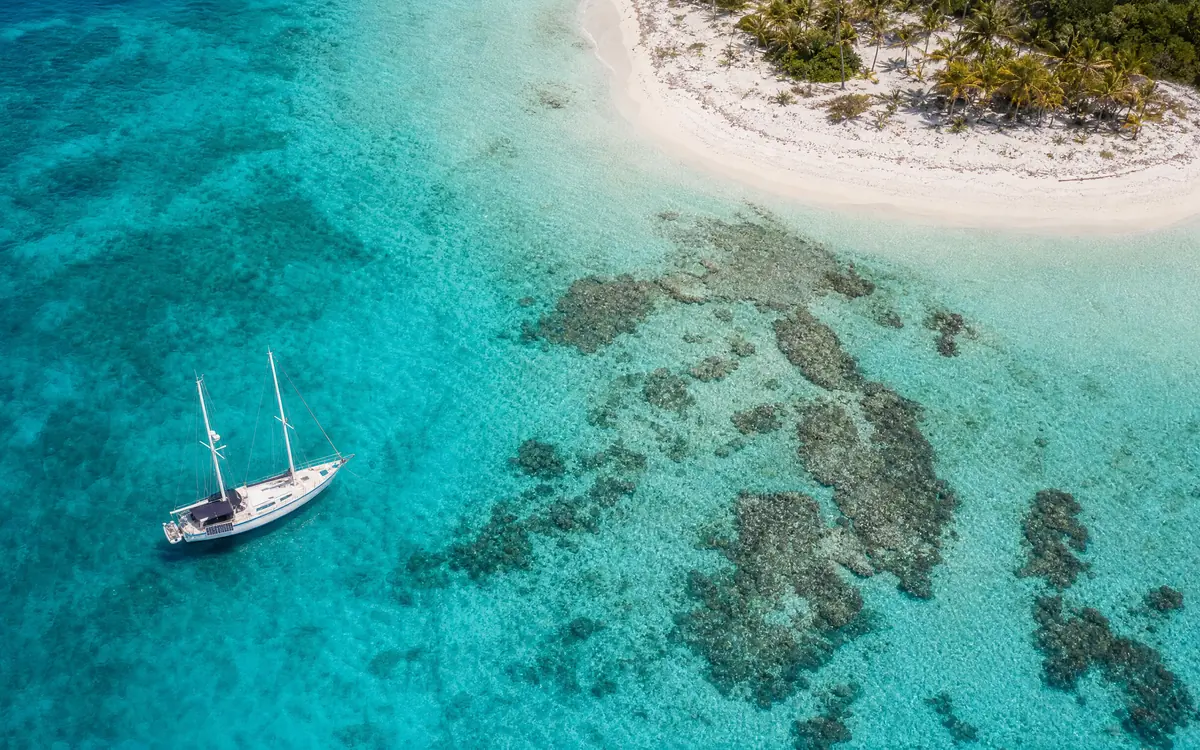 Aerial view of the Belize reef: turquoise lagoon, coral patches and a white sandbar